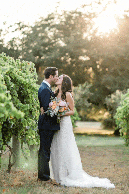 Wedding couple kissing each others in a vineyard
